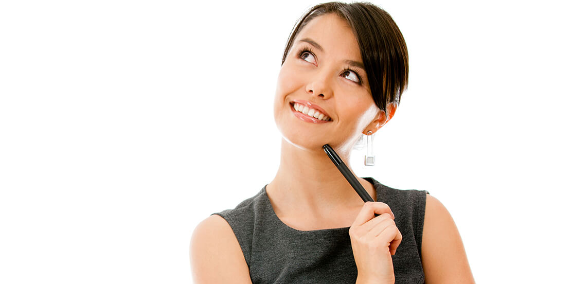Smiling young business woman looking up