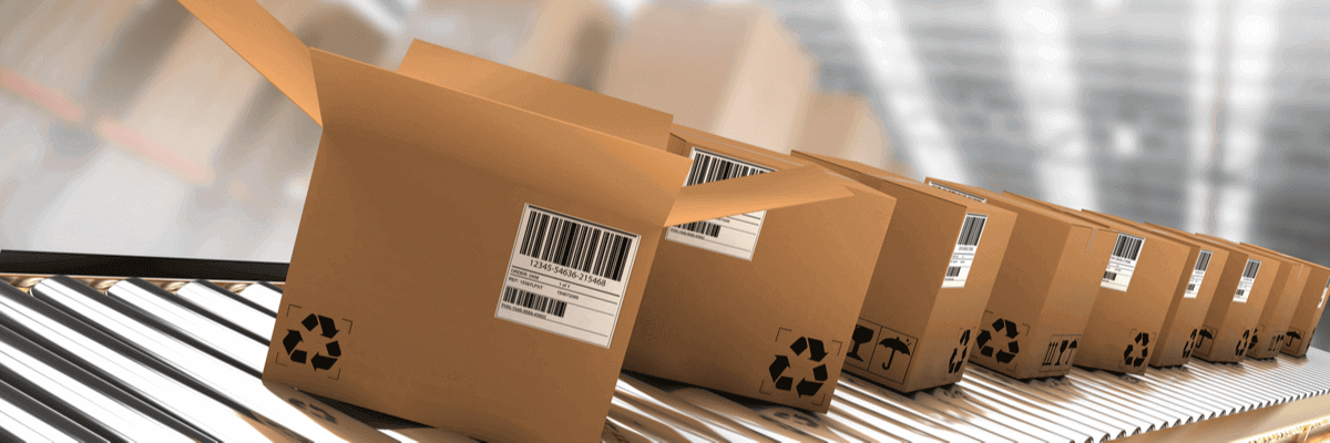 Row of brown boxes with labels on conveyor belt in warehouse