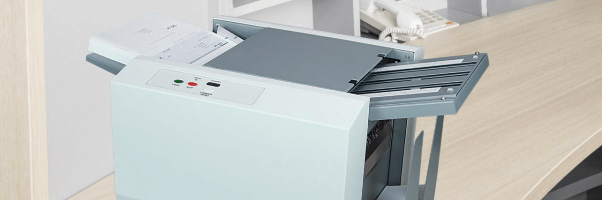 Close up image of a printer on a desk, finishing and mailing solutions machine