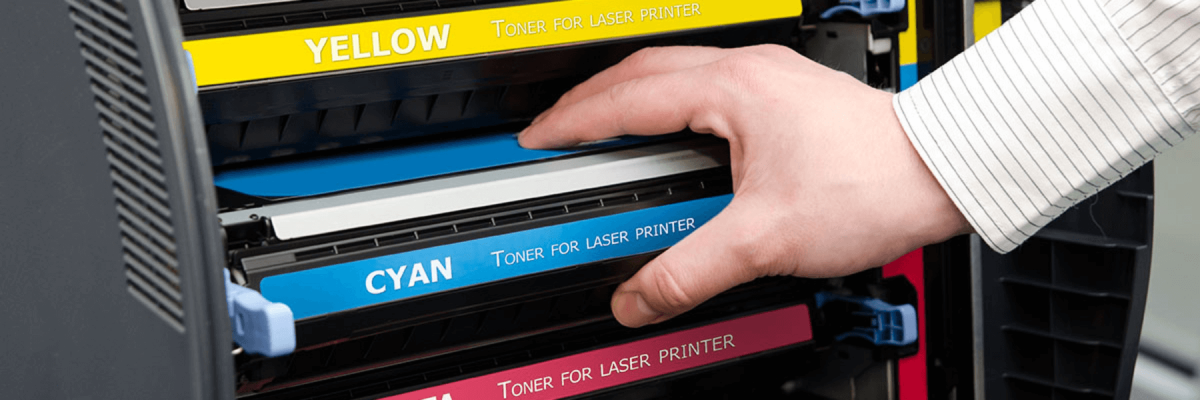 Close up of a hand pulling out or putting in an ink or toner cartridge from a printer or multifunction machine in an office, printer ink or toner supplies