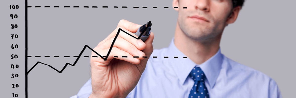 Business man in shirt and tie drawing a graph on a clear board