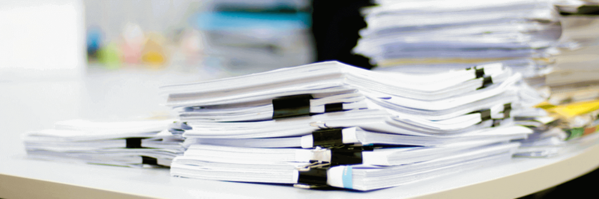 Close up of cluttered paper documents on a desk
