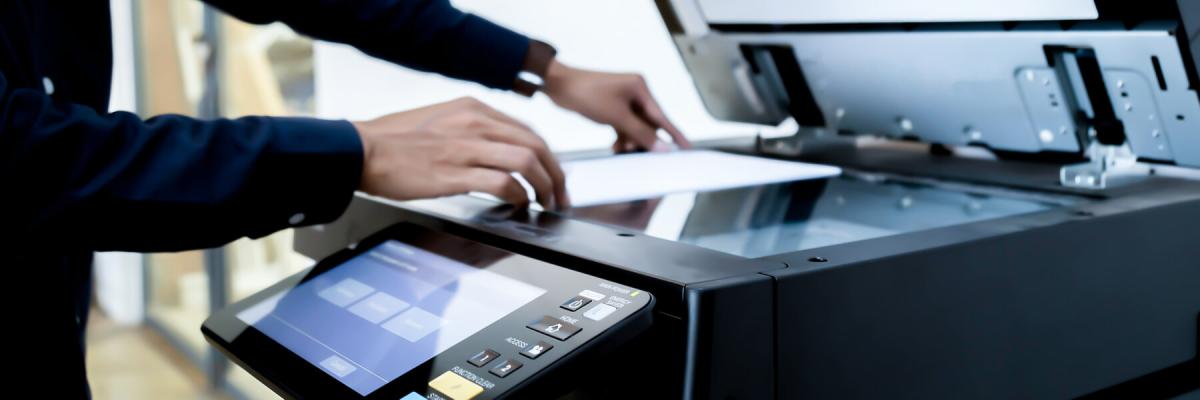 business person preparing a document to copy on copy machine
