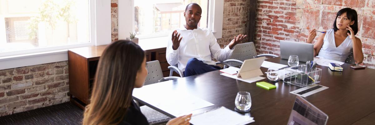 3 members of startup having a discussion around the table